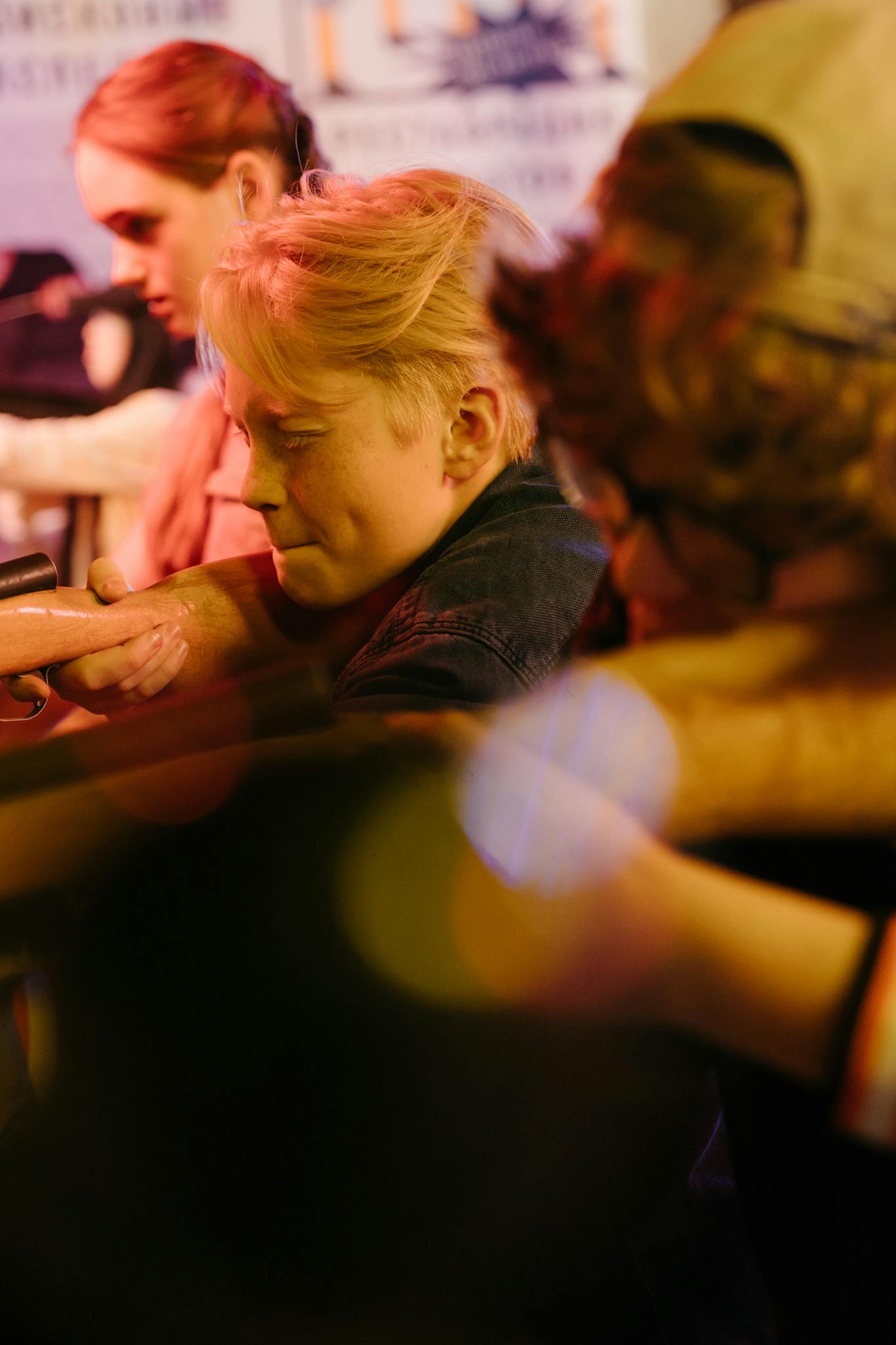 Teens having fun at a retro-themed shooting range in an amusement arcade.